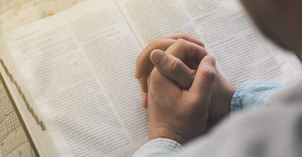 Recovery - photo of person praying reading the bible